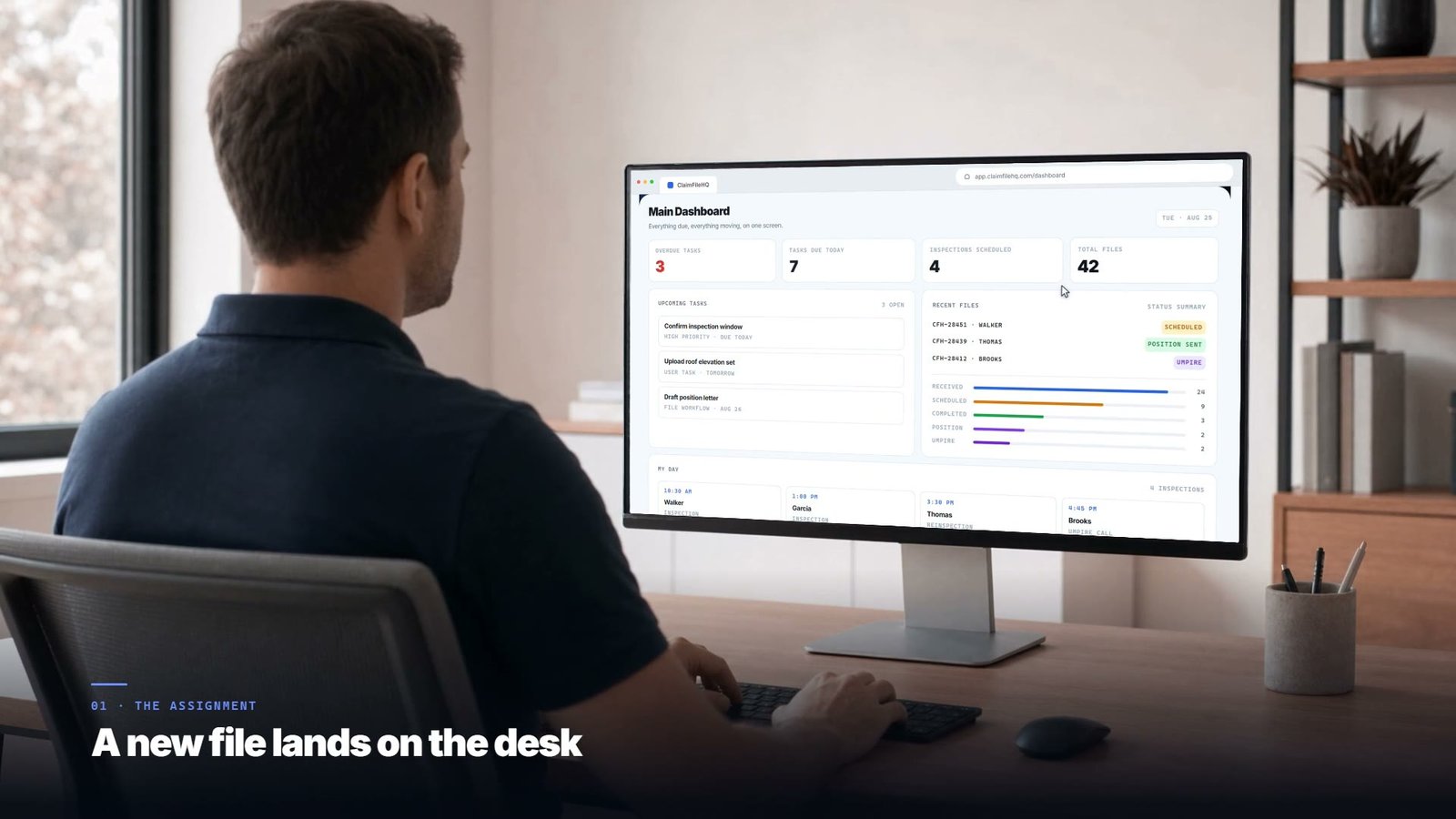 A property appraiser at a desk, opening a new claim assignment in ClaimFileHQ.